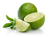 Whole and slice of lime with leaves