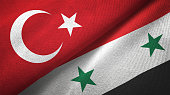 Syria and Turkey two flags together textile cloth fabric texture