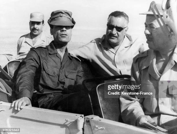 President Nasser and President Gaddafi are Sitting in a jeep and watching the manoeuvres while in front is Major-General Mohammed Fawzi, the Egyptian...