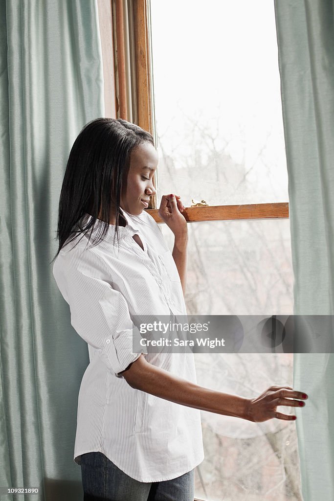 African American Woman Standing By Window