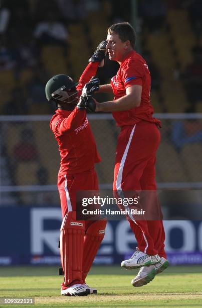 Ray Price of Zimbabwe celebrates with team mate Tatenda Taibu after taking the wicket of David Hussey of Australia during the 2011 ICC World Cup...