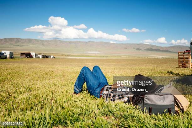 tired senior cowboy taking a nap outdoors in usa - cowboy sleeping stock pictures, royalty-free photos & images
