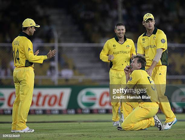 Brett Lee of Australia is congratulated by team mates after taking a catch from his own bowling to dismiss Charles Coventry of Zimbabwe during the...