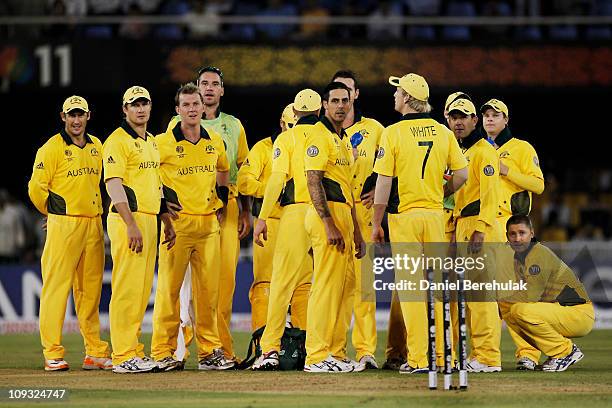 Players of the Australian team watch the replay of a successful referal dismissal of Mitchell Johnson during 2011 ICC World Cup Group A match between...