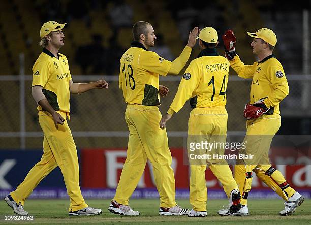 Jason Krejza of Australia celebrates with team mates after taking the wicket of Elton Chigumbura of Zimbabwe during the 2011 ICC World Cup Group A...