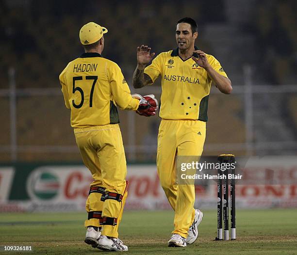 Mitchell Johnson of Australia celebrate with team mate Brad Haddin after taking the wicket of Graeme Cremer of Zimbabwe during the 2011 ICC World Cup...