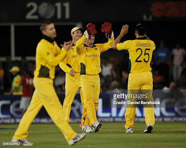 Mitchell Johnson of Australia celebrates victory with team mates Brad Haddin and David Hussey during 2011 ICC World Cup Group A match between...