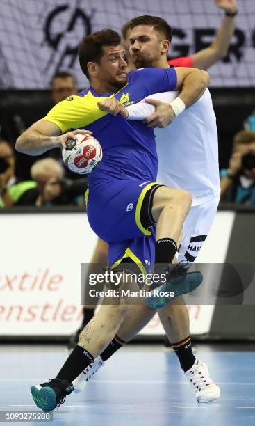 Fabian Weide of Germany challenges Jose Toledo of Brazil during the 26th IHF Men's World Championship group A match between Germany and Brazil at...