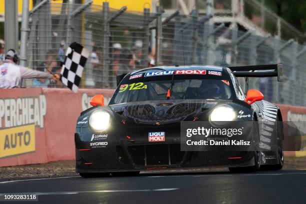 Matt Campbell drives the Porsche takes the chequred flag to win the Bathurst 12 Hour Race at Mount Panorama on January 31, 2019 in Bathurst,...