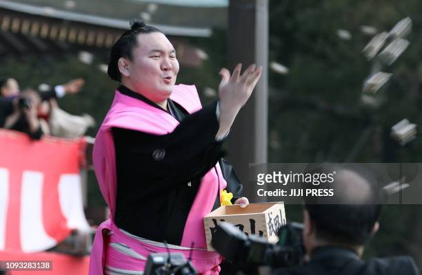 "Yokozuna" or sumo grand champion Hakuho of Mongolia takes a part in a bean-throwing ceremony to drive away evil spirits and bring good luck at the...