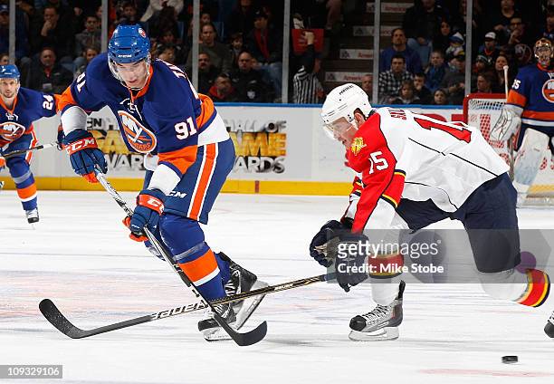 John Tavares the New York Islanders and Jack Skille of the Florida Panthers skate for position on February 21, 2011 at Nassau Coliseum in Uniondale,...