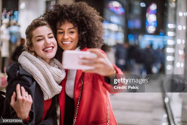 catching selfies on christmas shopping - italy winter stock pictures, royalty-free photos & images