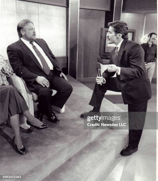 Richard Tinyes, father of murdered girl Kelly Ann Tinyes, talk with Geraldo Rivera during a taping of Rivera's show in Manhattan on April 18, 1990.