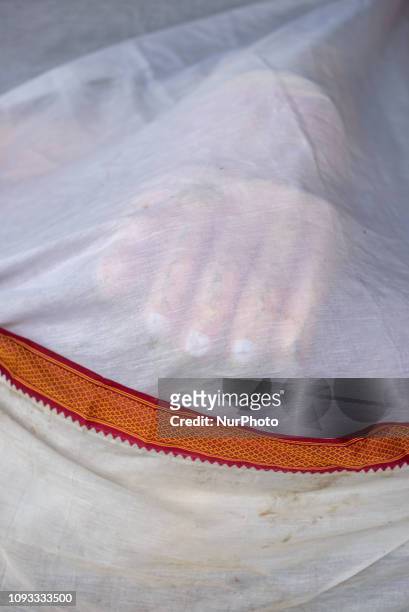 Covered statue of a Buddhist deity on George Town street, Penang Island, Malaysia, in January 2019. George Town is the capital of the Malaysian state...