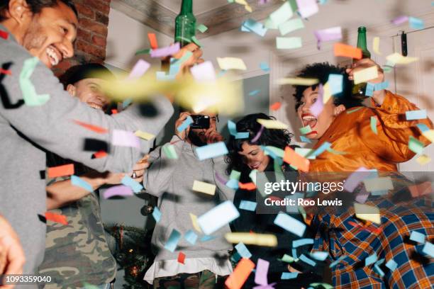 Group of young people at a party with confetti