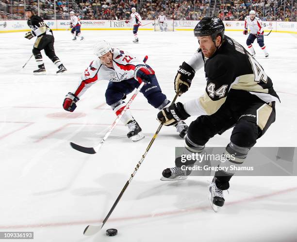 Brooks Orpik of the Pittsburgh Penguins controls the puck in front of Mike Knuble of the Washington Capitals on February 21, 2011 at Consol Energy...