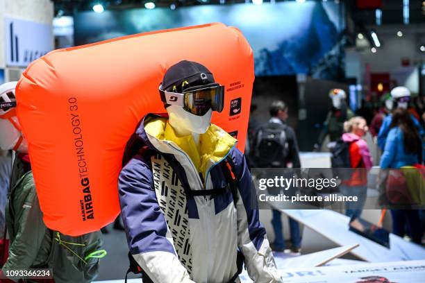 February 2018, Bavaria, München: A mannequin with an avalanche airbag, ski goggles, cap and jacket from various manufacturers, photographed at the...