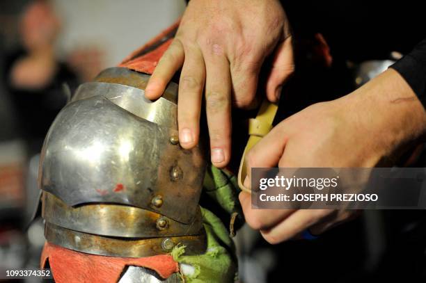 Armour is held on by leather straps, seen here as a knight puts on his leg armour, during a chapter war match between the Nashua Nightmares and the...