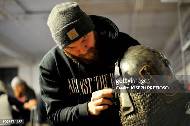 Lane Atteridge polishes his helmet before the fights begin during a chapter war match between the Nashua Nightmares and the Manchester Monarchs at...