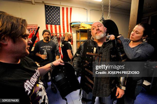 Knight Joe Fontenot receives some help putting his super body armour on, during a chapter war match between the Nashua Nightmares and the Manchester...