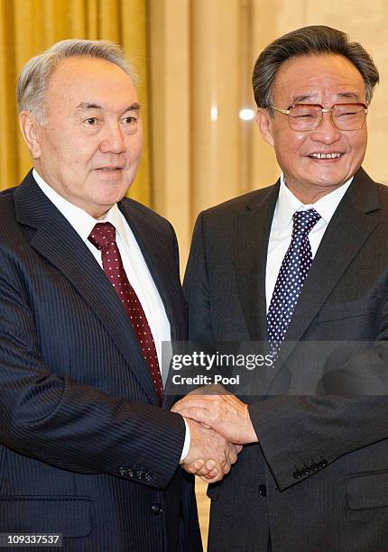 Kazakh President Nursultan Nazarbayev shakes hands with Chairman of the Standing Committee of the National People's Congress Wu Bangguo at the Great...