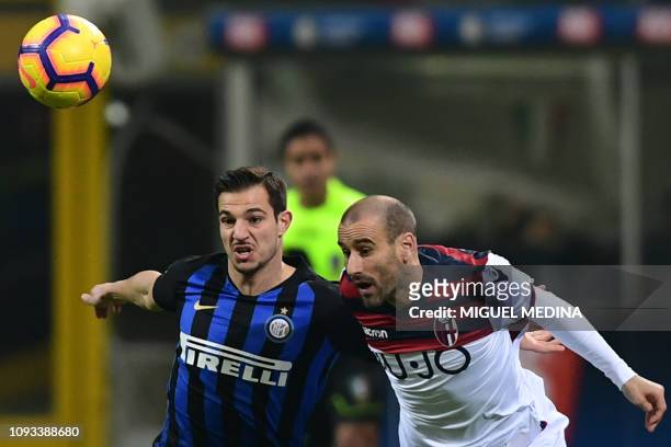 Inter Milan's Portuguese defender Cedric Soares and Bologna's Argentine forward Rodrigo Palacio go for the ball during the Italian Serie A football...