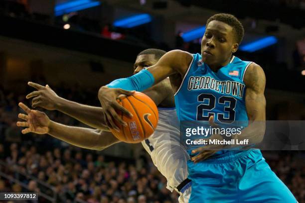 Josh LeBlanc of the Georgetown Hoyas grabs a rebound against Eric Paschall of the Villanova Wildcats in the first half at the Wells Fargo Center on...