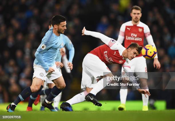 Denis Suarez of Arsenal evades David Silva of Manchester City during the Premier League match between Manchester City and Arsenal FC at Etihad...