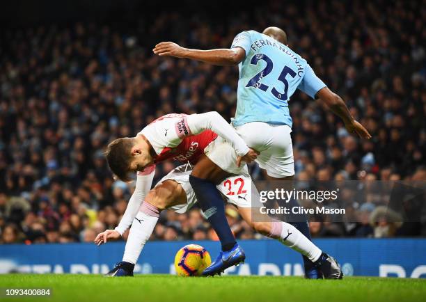 Denis Suarez of Arsenal tangles with Fernandinho of Manchester City during the Premier League match between Manchester City and Arsenal FC at Etihad...