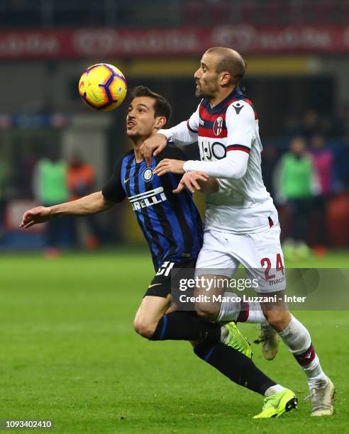 Cedric Soares of FC Internazionale competes for the ball with Rodrigo Palacio of Bologna FC during the Serie A match between FC Internazionale and...