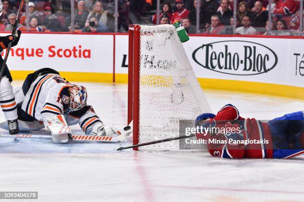 Max Domi of the Montreal Canadiens gets the puck past the stick of goaltender Mikko Koskinen of the Edmonton Oilers during the NHL game at the Bell...