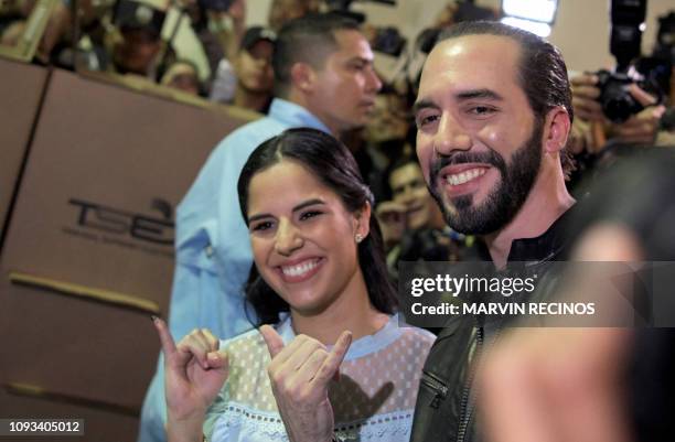 Salvadorean presidential candidate Nayib Bukele , of the Great National Alliance , and his wife Gabriela Rodriguez, pose after voting during the...