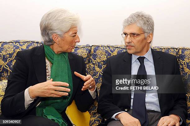 French Economy, Finance and Industry Minister Christine Lagarde speaks with Tunisian International Cooperation Minister Mohamed Nouri Jouini on...