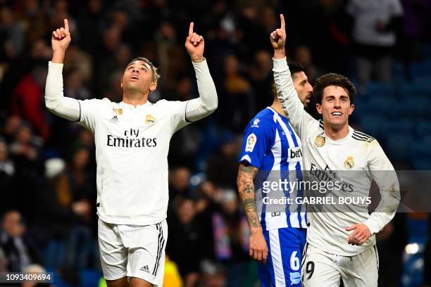 Real Madrid's Spanish-Dominican forward Mariano celebrates his goal with Real Madrid's Spanish defender Alvaro Odriozola during the Spanish league...