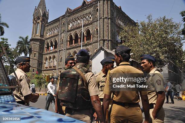 Security persons stand guard at Bombay High Court during a hearing for the verdict on Ajmal Kasab's death sentence in Mumbai on Monday. The court...