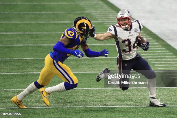 Rex Burkhead of the New England Patriots runs the ball against John Johnson III of the Los Angeles Rams in the first quarter of Super Bowl LIII at...