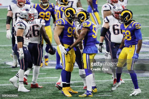 Dante Fowler Jr. #56 of the Los Angeles Rams and teammate Ndamukong Suh celebrate a defensive play in the first half of the Super Bowl LIII against...