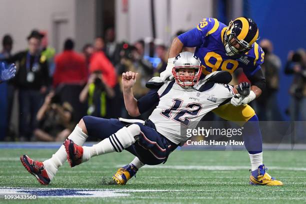 Tom Brady of the New England Patriots is sacked by Aaron Donald of the Los Angeles Rams in the first quarter during Super Bowl LIII at Mercedes-Benz...