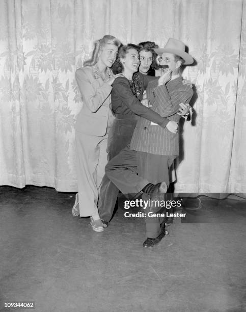 American comedian and actor Groucho Marx clowns around with musical group the Andrews Sisters, early 1940s. Pictured are from left, Patty Andrews,...