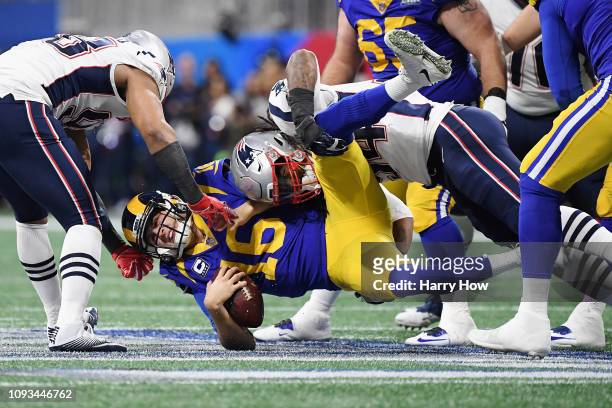 Trey Flowers and Dont'a Hightower of the New England Patriots sack Jared Goff of the Los Angeles Rams in the first half during Super Bowl LIII at...
