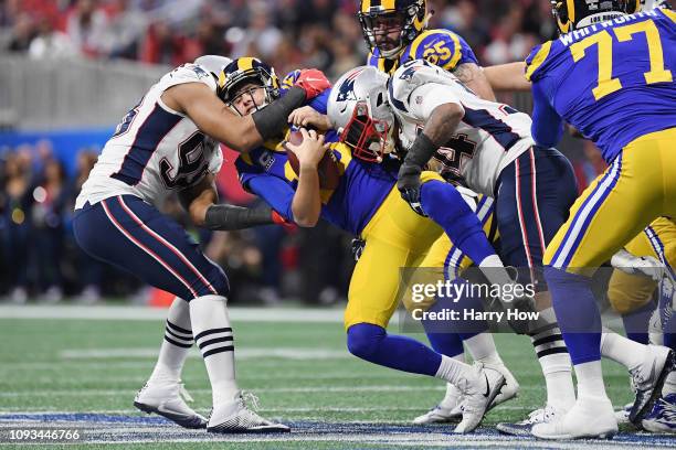 Trey Flowers and Dont'a Hightower of the New England Patriots sack Jared Goff of the Los Angeles Rams in the first half during Super Bowl LIII at...