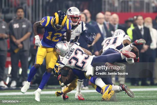 Patrick Chung of the New England Patriots tackles Todd Gurley II of the Los Angeles Rams in the second half during Super Bowl LIII at Mercedes-Benz...
