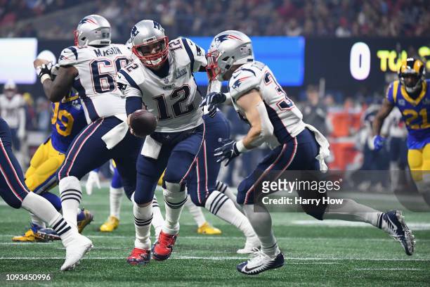 Tom Brady of the New England Patriots hands the ball of to Rex Burkhead in the second half during Super Bowl LIII against the Los Angeles Rams at...