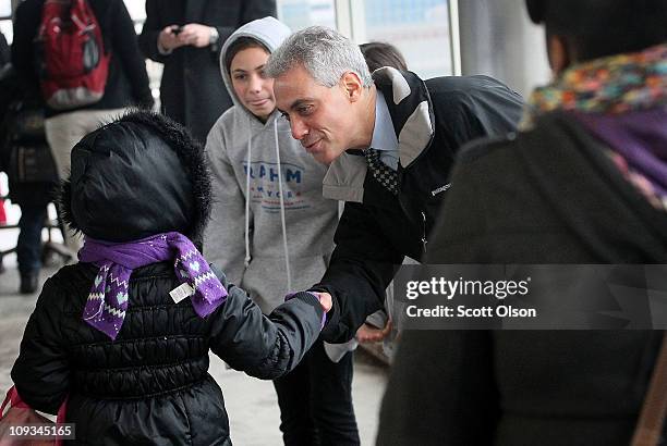 Mayoral candidate Rahm Emanuel greets commuters with his daughter Ilana at an "L" train station while campaigning February 22, 2011 in Chicago,...