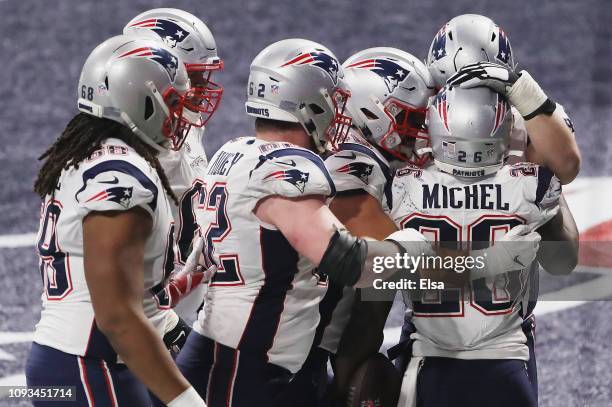 Sony Michel of the New England Patriots celebrates with teammates after scoring a touchdown against the Los Angeles Rams in the fourth quarter during...