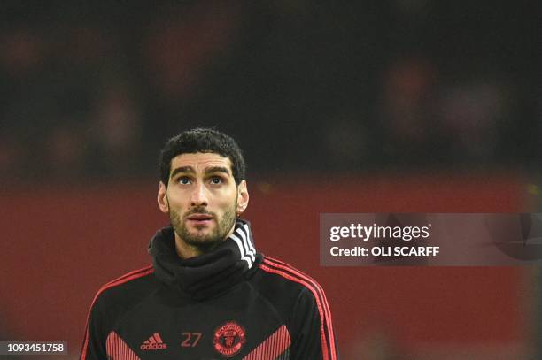 This file photo taken on December 5, 2018 shows Manchester United's Belgian midfielder Marouane Fellaini warming up for the English Premier League...