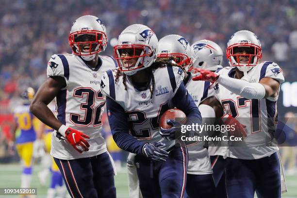 The New England Patriots celebrate with Stephon Gilmore after Gilmore makes an interception in the fourth quarter during Super Bowl LIII against the...