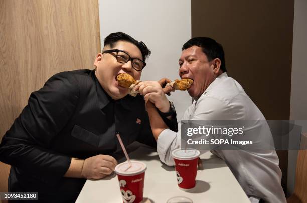 Rodrigo Duterte and Kim Jong-un impersonators seen eating lunch in a filipino fast food Jollibee chain restaurant in Cental, Hong Kong. The...