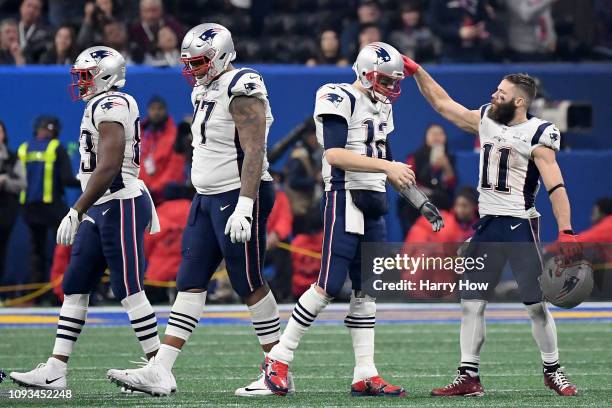 Julian Edelman reacts with Tom Brady of the New England Patriots after the Patriots defeat the Los Angeles Rams 13-3 during Super Bowl LIII at...