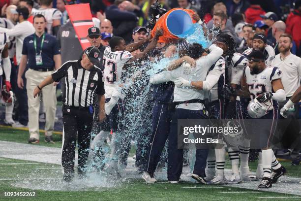 New England Patriots players give head coach Bill Belichick a Gatorade shower after winning the Super Bowl LIII at Mercedes-Benz Stadium on February...